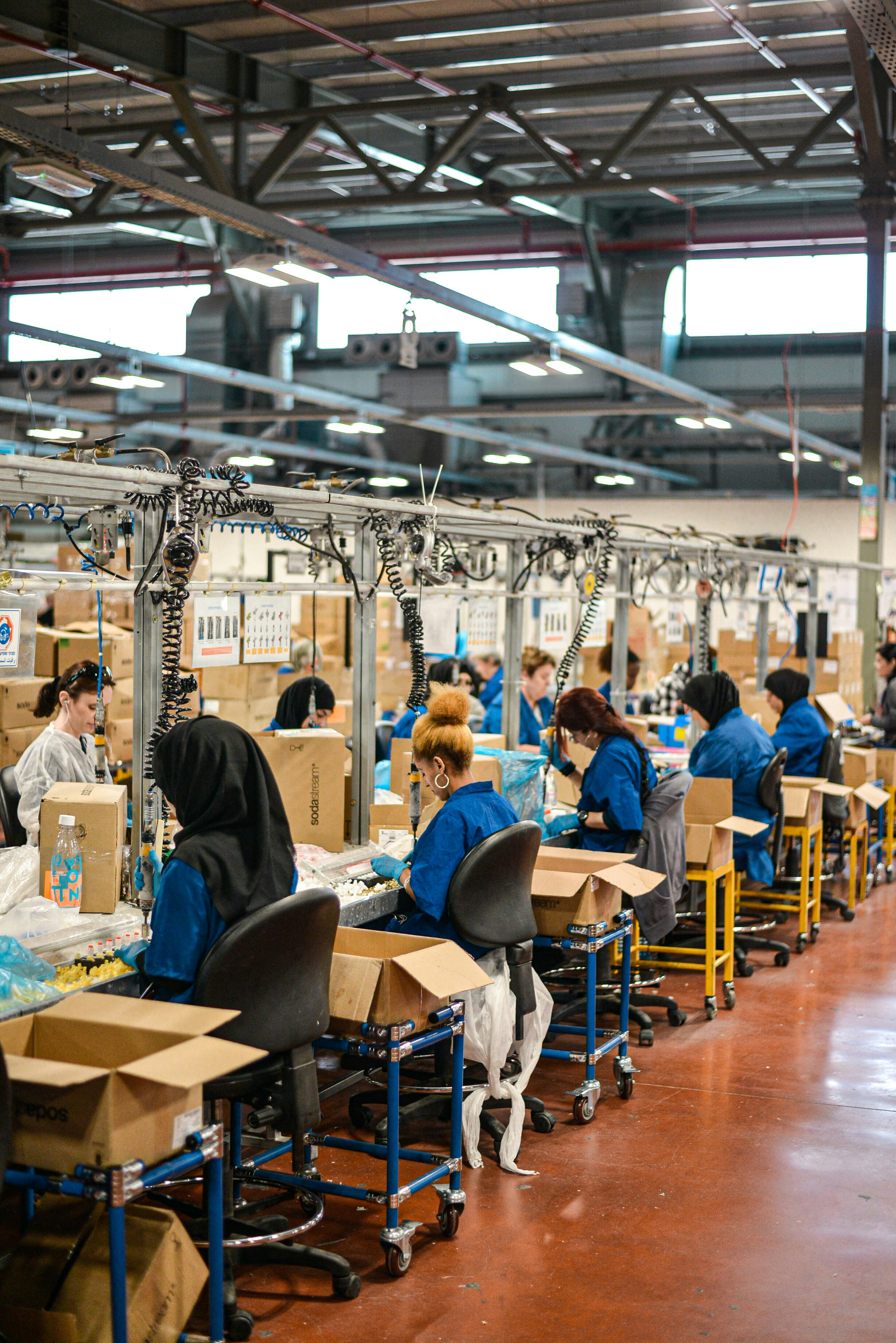 Workers on a factory packing line preparing consumer products