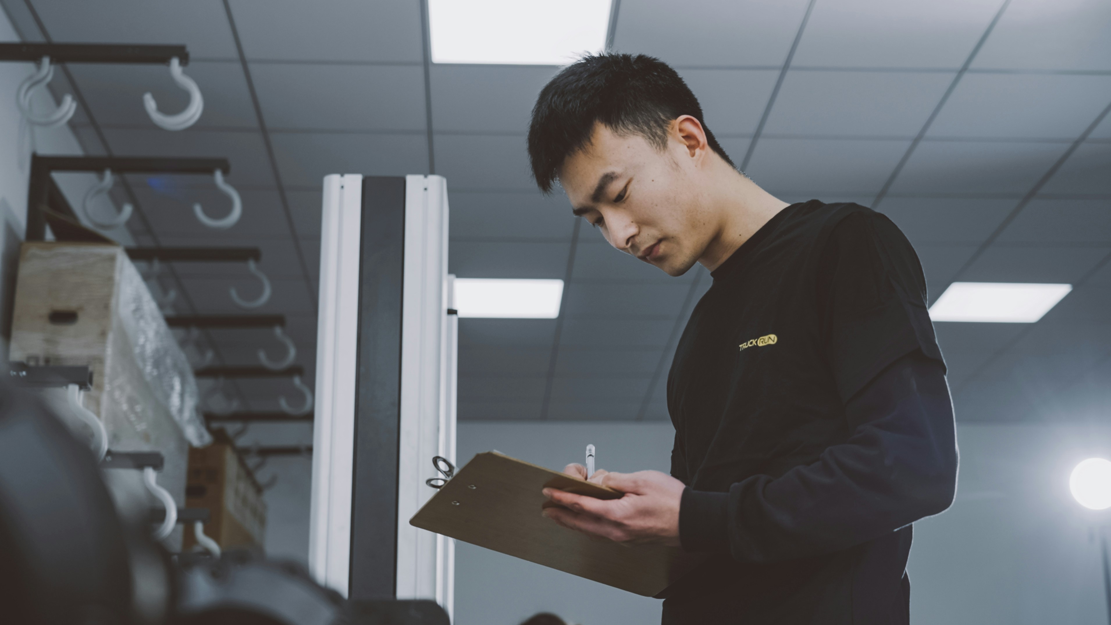 Inspector writing quality control notes during a product check