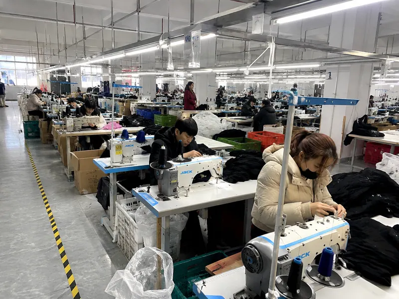 Illustrative garment production workshop with sewing workers in China